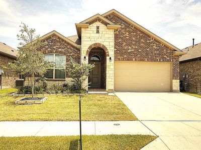 View of front facade with a garage, central AC, and a front lawn | Image 1