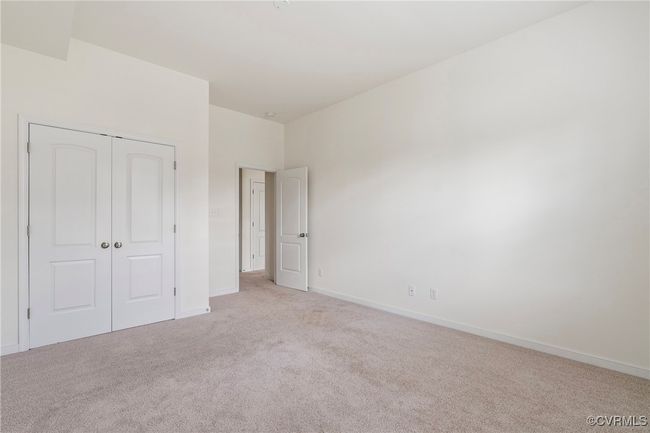 Unfurnished bedroom featuring light carpet and a closet | Image 42
