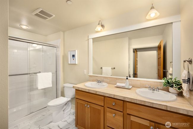 Primary bath includes new flooring, shower door and new toilet. | Image 19