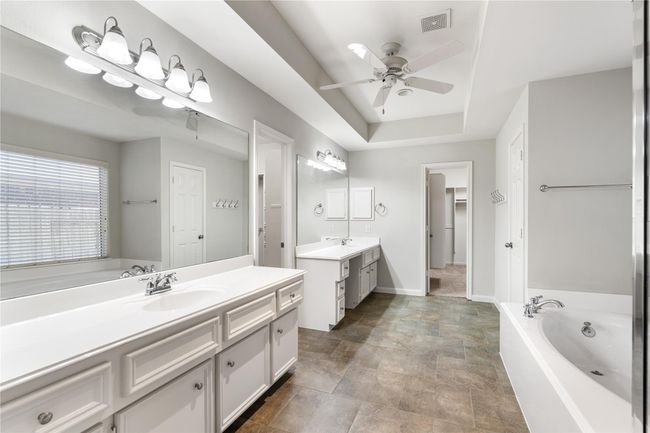 Bright and spacious primary bathroom with access to TWO walk-in his and her closets. | Image 15