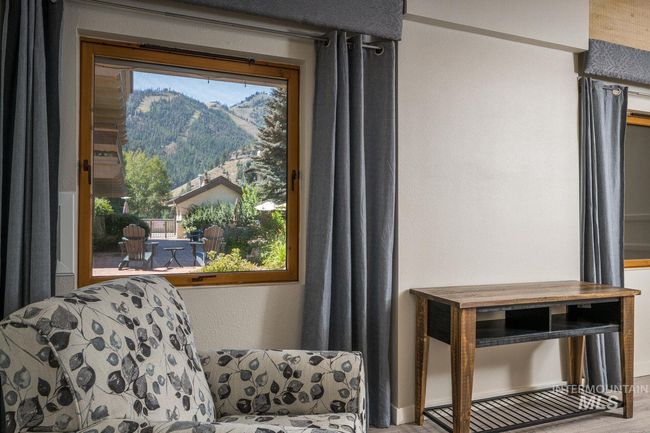 Living area featuring a mountain view and wood finished floors | Image 5