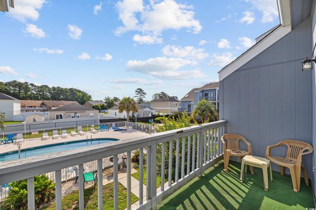Balcony with a residential view and view of pool | Image 18
