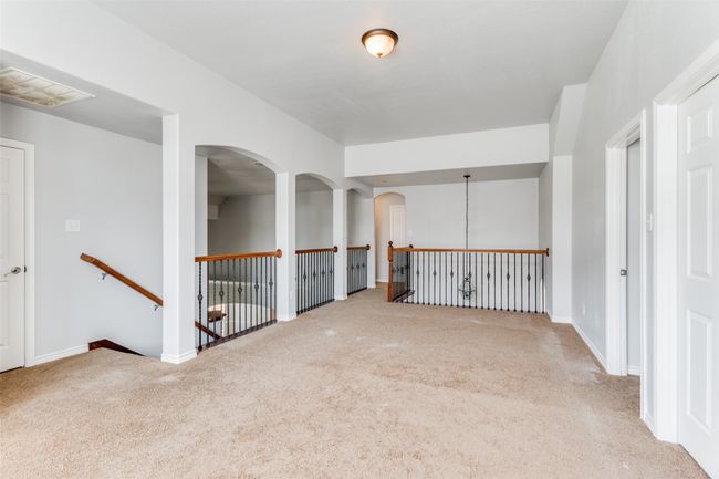 Empty room with carpet and arched walkways | Image 24