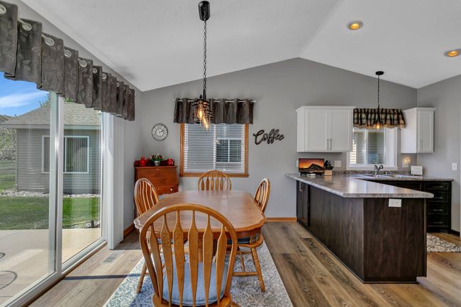 Slide doors leading to back patio allows tons of natural light into the dining space. | Image 5