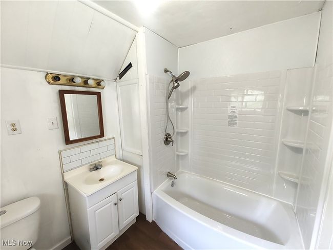Full bath with vanity, toilet, shower / washtub combination, and wood finished floors | Image 30