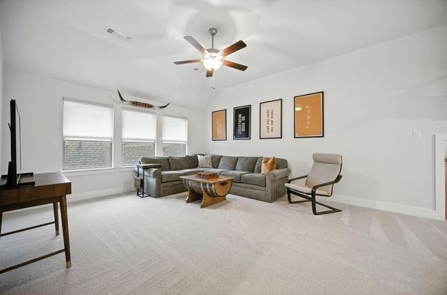 Upstairs Family room featuring carpet floors, ceiling fan, and vaulted ceiling | Image 28