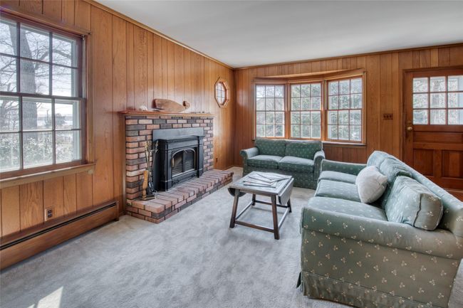 living room with wood burning fireplace | Image 6