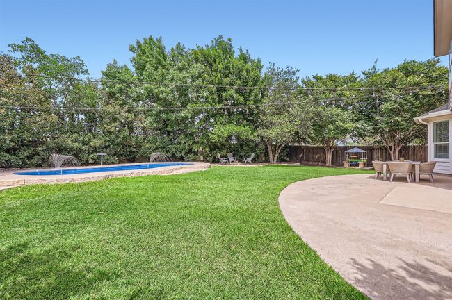 Large backyard with room to run, play, and cool off in the pool. | Image 29