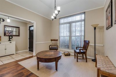 Sitting room with a notable chandelier, ornamental molding, and light hardwood / wood-style flooring | Image 3