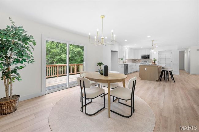 Dining room with a chandelier, light wood finished floors, and recessed lighting | Image 21