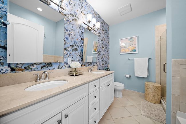 Full bathroom featuring tile patterned flooring, a sink, baseboards, and a shower stall | Image 20