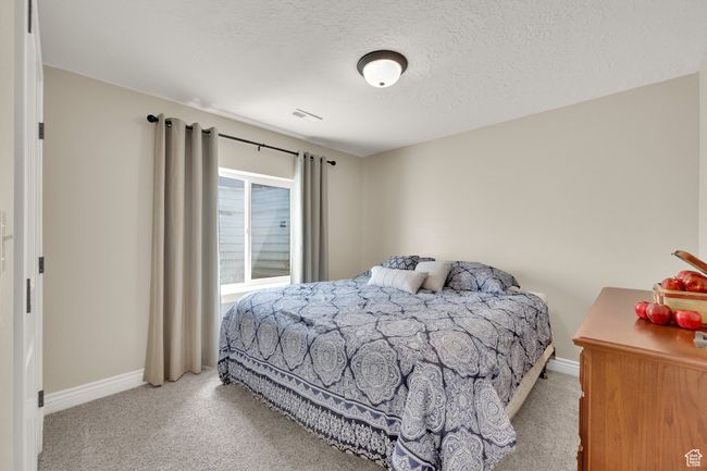 Bedroom with carpet floors and a textured ceiling | Image 19