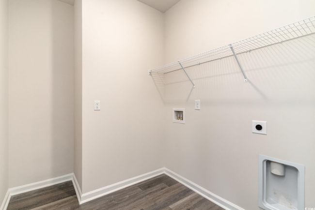 Laundry room featuring washer hookup, electric dryer hookup, dark wood-style flooring, and baseboards | Image 24