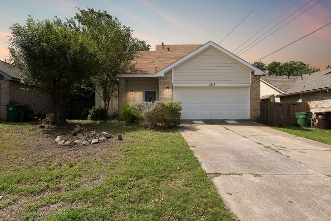 Ranch-style house with brick siding, driveway, and a garage | Image 30