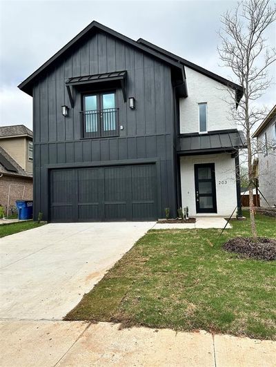 View of front of property with a front yard and a garage | Image 1