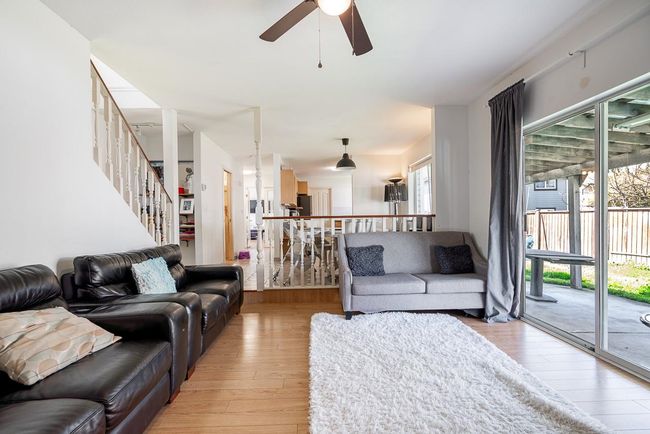 Living area with stairway, a ceiling fan, and light wood-type flooring | Image 10