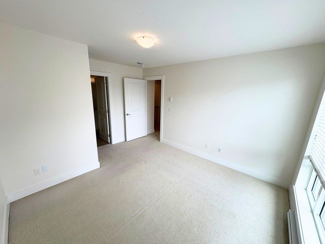 Unfurnished room featuring light colored carpet and baseboards | Image 6