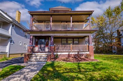 View of front facade with a front yard, covered porch, and a balcony | Image 2