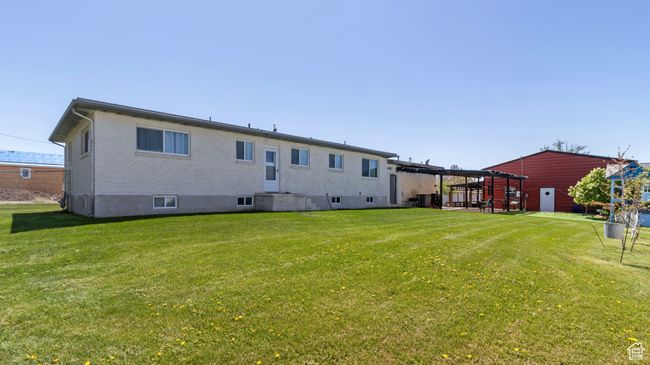 Rear view of house featuring a lawn and brick siding | Image 25