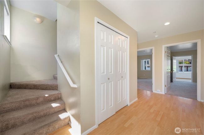 Entry features 3/4 bath unpictured to the right, 2 bedrooms with separate access to bonus/sun room, utility closet and large secondary entry closet | Image 7