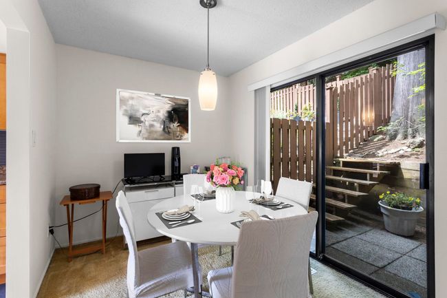Carpeted dining area featuring baseboards | Image 10