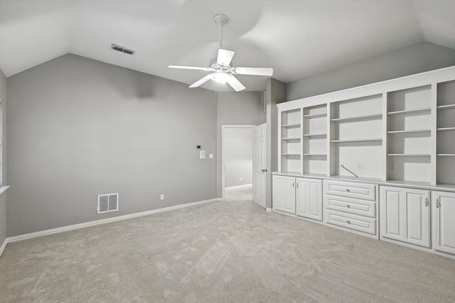 Unfurnished bedroom with vaulted ceiling, light carpet, and ceiling fan | Image 22