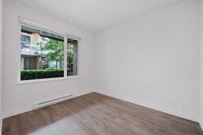 Spare room with a baseboard heating unit and wood finished floors | Image 20