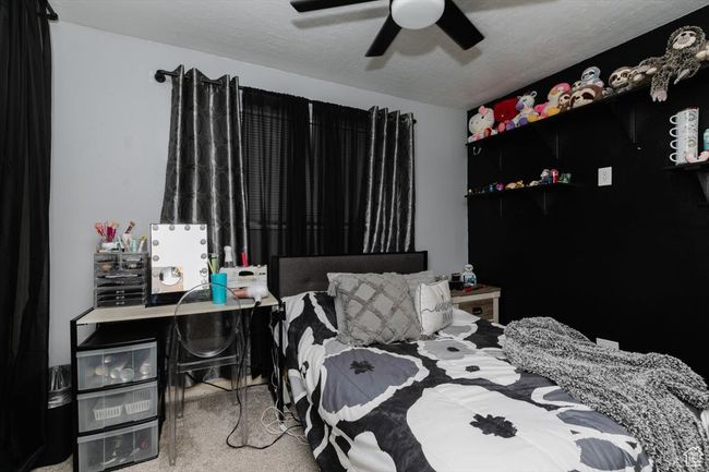 Bedroom with a ceiling fan and carpet floors | Image 23