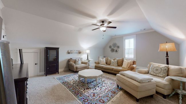 This spacious bonus room is perfect for movie nights, playtime, or a second living area—featuring plush carpet, built-in storage, and plenty of room to spread out and make it your own. | Image 39