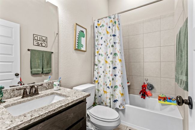Full bathroom featuring vanity and shower / bathtub combination with curtain | Image 20