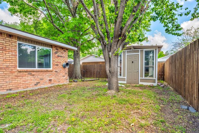 Fenced backyard featuring an outbuilding | Image 37