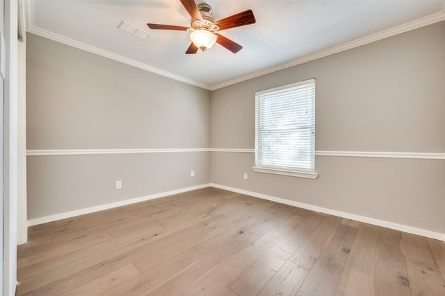 Empty room with ornamental molding, ceiling fan, and wood-type flooring | Image 21