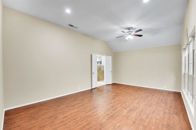Spare room with hardwood / wood-style floors, vaulted ceiling, and ceiling fan | Image 27