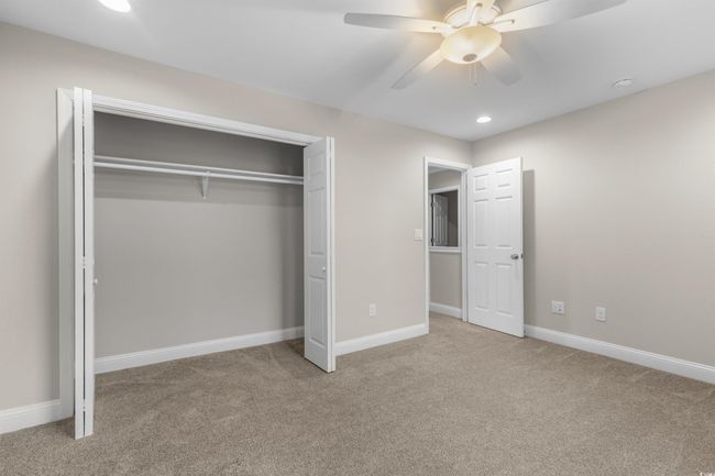 Unfurnished bedroom with carpet, a closet, recessed lighting, baseboards, and ceiling fan | Image 34