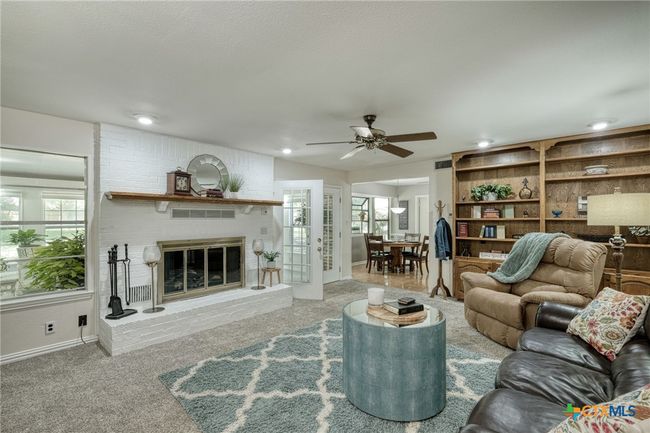 Den/Family room with fireplace and built in bookshelves. | Image 11