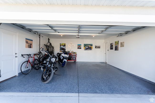 Garage featuring a garage door opener and baseboards | Image 18
