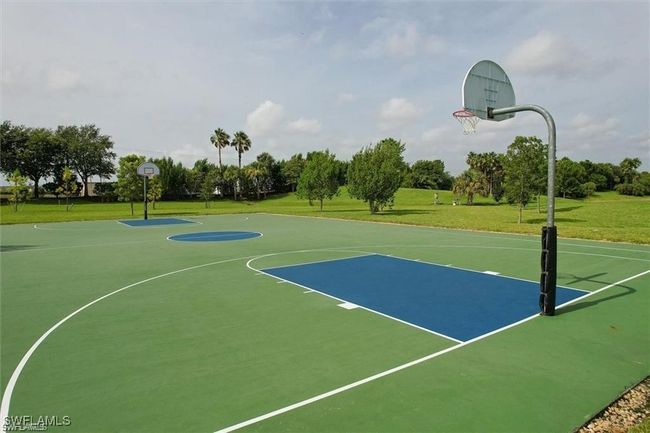 View of basketball court featuring community basketball court and a lawn | Image 31
