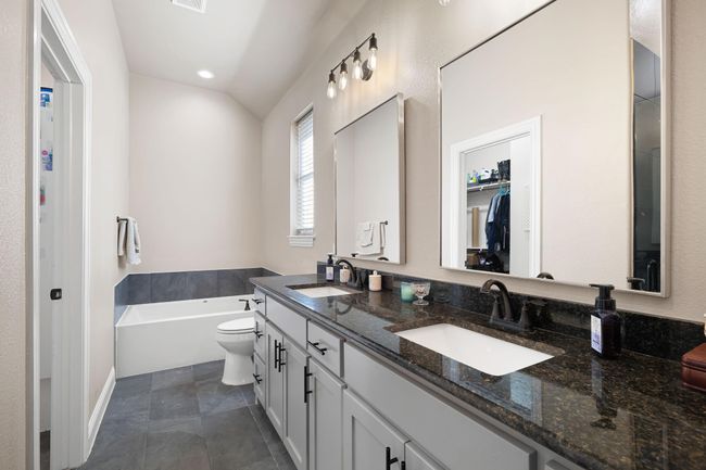 Bathroom featuring double vanity, recessed lighting, a bath, and a sink | Image 25