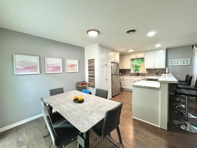 Dining space with sink and wood-type flooring | Image 1