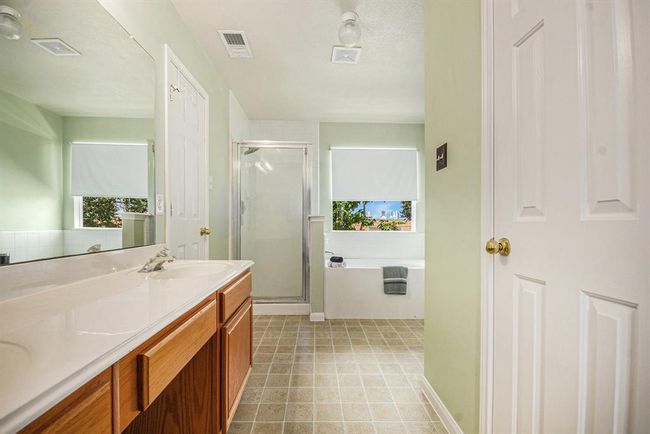 en suite with soaking tub, separate stand up shower, double sinks and two closets with one being a large walk in | Image 21
