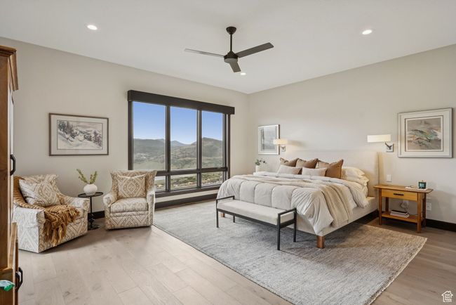 Bedroom with a mountain view, light wood-style flooring, recessed lighting, and ceiling fan | Image 32
