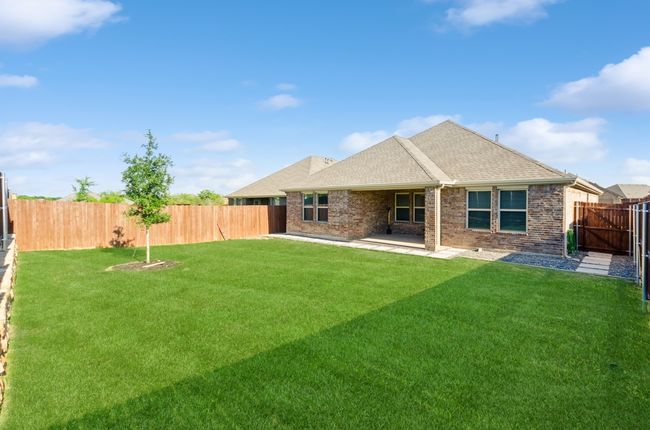 Rear view of property with brick siding, a patio, and roof with shingles | Image 30