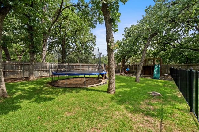 View of yard with a trampoline and a playground | Image 34