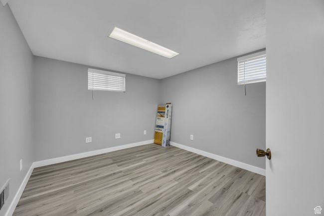 Below grade area with wood finished floors and baseboards | Image 20