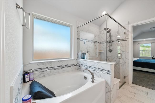 Ensuite bathroom featuring a garden tub, a marble finish shower, and marble finish flooring | Image 24