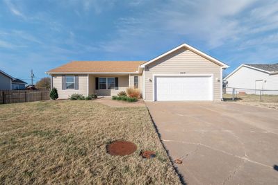 Single story home with a garage and a front lawn | Image 1