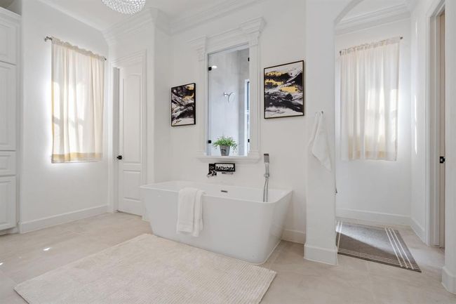 Another view of the primary bathroom, featuring a separate soaking tub, spacious walk-in shower, and a private water closet. Neutral finishes create a serene, spa-like atmosphere. | Image 22