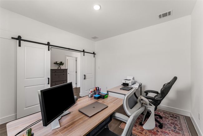 Office featuring a barn door and wood | Image 15