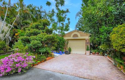 Spectacular curb appeal between the lush, colorful landscaping & the brick paver driveway, , rare in this neighborhood. | Image 3