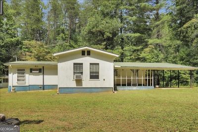 This home has it's own separate driveway, out buildings and address from 1120 (both included with the sale | Image 2